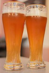 two beer glasses on a white table