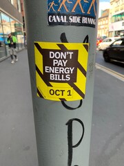 Sticker on a pole in Manchester for the political protest Don’t Pay Energy Bills for the United Kingdom