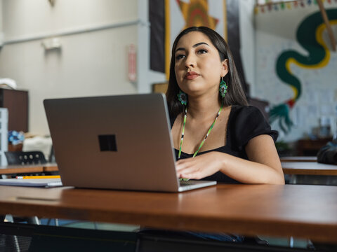 Close-up of Native girl student on her computer during class while looking up
