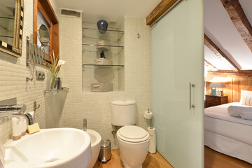 En-suite bathroom with tiled tiles, translucent glass sliding door and white porcelain design toilets