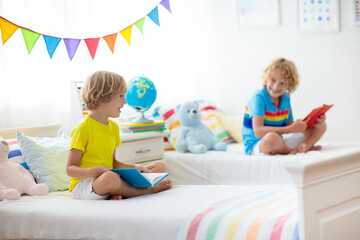 Child reading in bed. Kids read. Boy at home.