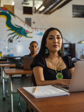 Native student looking directly at the camera and smiling in class