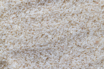 a pile of scattered white rice on the kitchen table