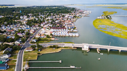 View of Chincoteague Island and the road along the bay. houses and motels with parking lots. View...