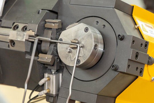 CNC bending machine bends steel wire. Formation of a bent part. Wire bending machine