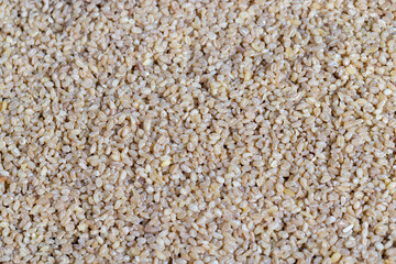 Fresh uncooked bulgur porridge on the table