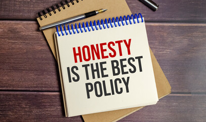 honesty is the best policy words on notepad and wooden background