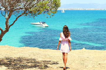 Cute girl looking at the sea. Relaxed atmosphere. Thoughtful girl at the water. Cinematic Film-Like. Cute charming girl, Spain, Mallorca. Attractive brunette with curly