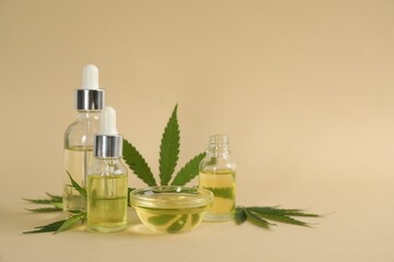 CBD oil and THC tincture with hemp leaves on beige background. Space for text