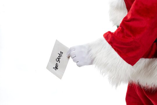 Santa Claus holding Dear Santa letter in gloved hand for Christmas