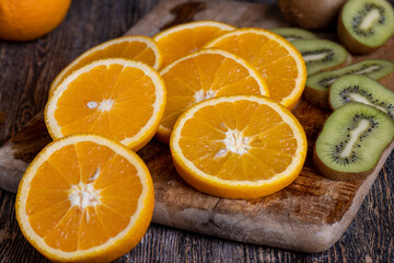 uncut orange on a wooden chopping board