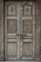 Ancient wooden carved door decoration. Antique old Indian door with the brass door handle.