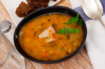 Rassolnik, russian soup made of pearl barley, pickled cucumbers and meat. Portion of soup.