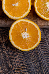 uncut orange on a wooden chopping board