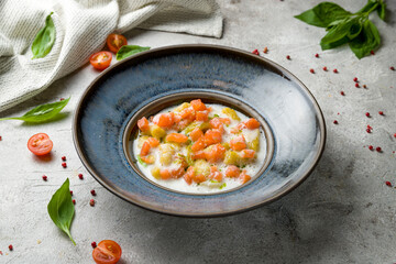 gnocchi with seafood and fresh salmon on plate on grey table