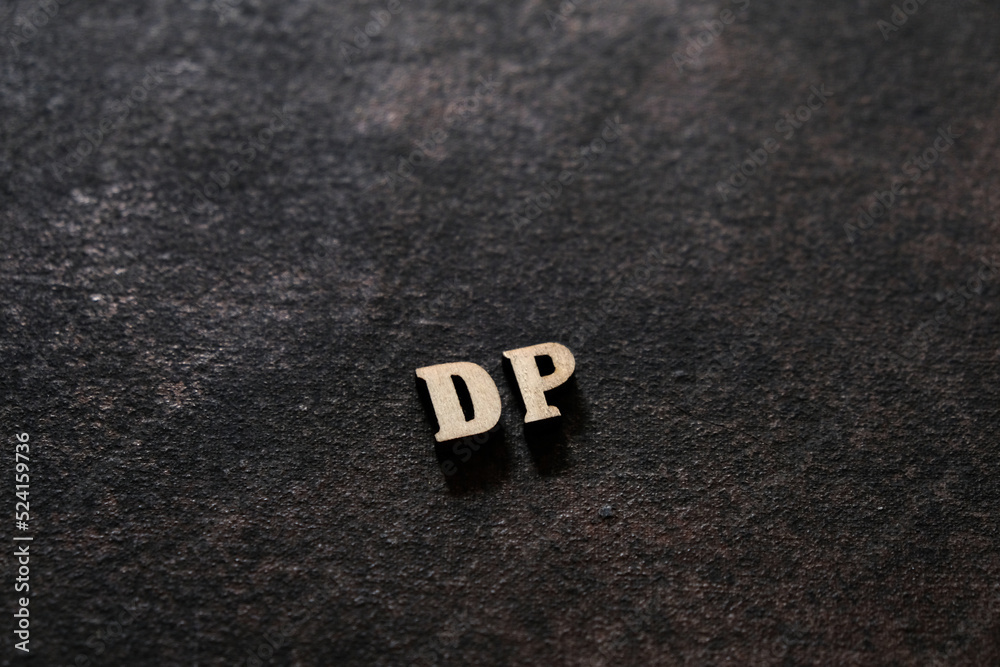 Fototapete the letters d and p above the dark field. initials dp