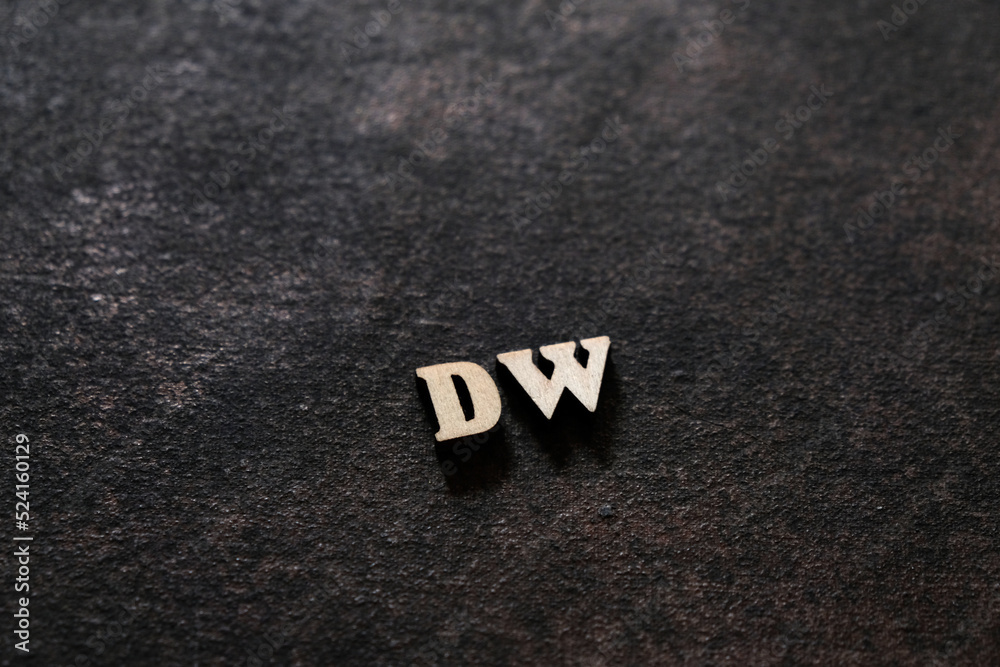 Wall mural the letters d and w above the dark field. initials dw