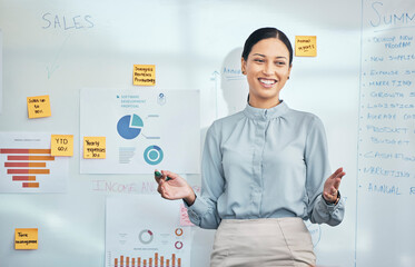 Presentation, female leader and speaker explaining graphs, charts and data on a whiteboard at a seminar, business meeting workshop. Happy business economist analyst talking about growth and profit