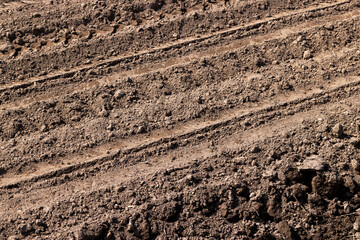 plowed soil in an agricultural field during tillage