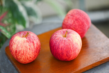 apple fruit on the wooden table, ripe red apples