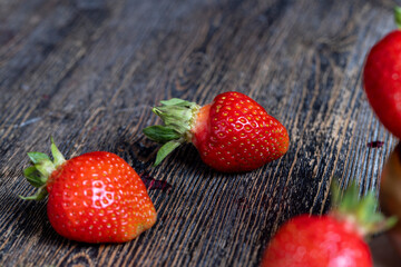 Ripe red strawberries lying on a wooden tray