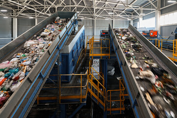 Conveyors carry trash and empty platforms at recycling plant