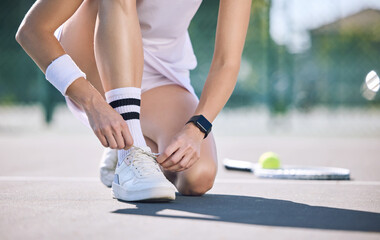 Female tennis player foot and hands tying shoelaces before game match on outdoor sports court....