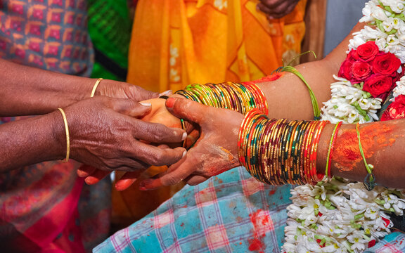A close-up shot of a baby shower in Tamil Nadu, South India. bangles Ceremony.