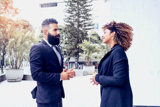 Businessmen Friends Talking Outside Building With Suit, Elegant Outdoors On Sunny Day, Business Couple Talking. Woman And Man.