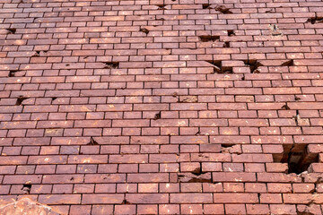 An old brick wall with various damages