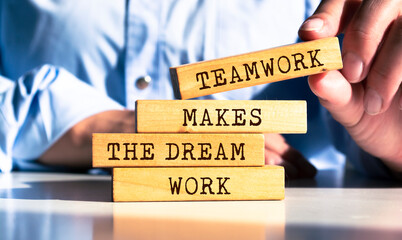 Wooden blocks with words 'Teamwork Makes the Dream Work'.