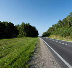 Fototapeta na wymiar Paved highway with plants