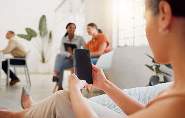 Businesswoman on a phone with blank screen copy for website, marketing or advertising app with colleagues in background. Corporate worker holding, showing copy space on cellphone in vibrant workplace