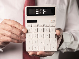 ETF analysis concept. Word on calculator. High quality photo