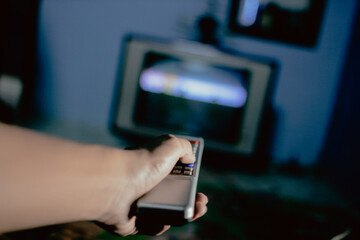 hand holding a remote control for tv