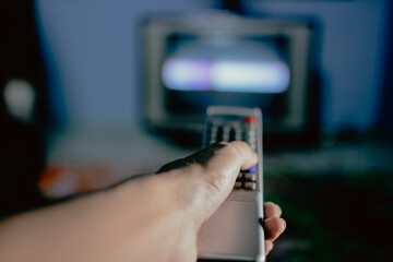 hand holding a remote control for tv