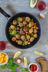 Dinner table with various snacks in the concept of homemade food, vegetables, herbs, fried steak in a pan, new potatoes