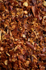 background crushed red cayenne pepper, dried chili flakes and seeds isolated on white background
