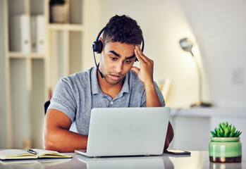 . Bored, tired and working customer service web support worker on an online computer call. Internet helpdesk male employee with a headset and headache feeling overworked from digital consulting job.