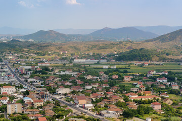 Fototapeta na wymiar Picturesque view of neighborhoods Skodra in Albania on the background of mountains at sunny summer day, seen from Rozafa fortress.