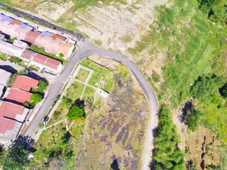Abstract Defocused Blurred Background Aerial photography a view of a remote residential area in the middle of a forest and mountain slope in the Cikancung area - Indonesia. Not Focus