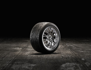 Single car tire on a garage floor. Rubber tire with shiny chrome rim from side view. 3d rendering