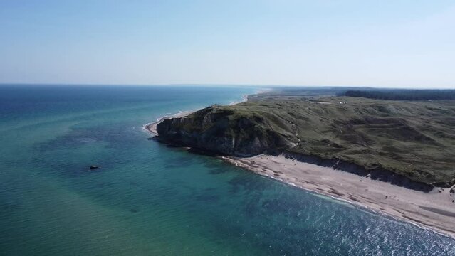the well-known cliffs of bulbjerg on the north sea in denmark, filmed from the sea with a drone, breathtaking scenery