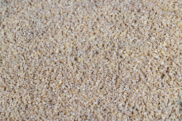 Fresh uncooked bulgur porridge on the table