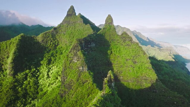 Sunny landscape tropical rain forest jungle island Kauai on background majestic ancient volcano in Na Pali nature park. 4K aerial view majestic green mountain peaks of Hawaii island, nature background