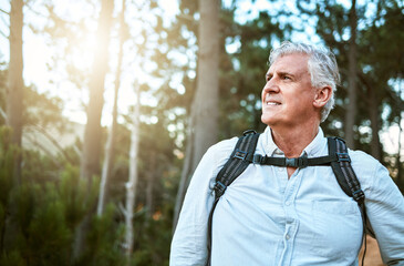 . Senior man walking on hike in nature, looking at view on mountain and hiking on a relaxing getaway vacation alone in the countryside. Retired, mature and happy guy on walk for exercise and fitness.