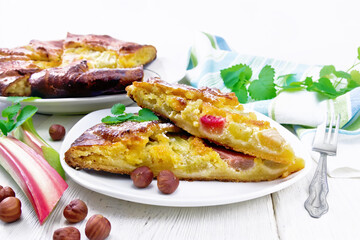 Tart with rhubarb and nut cream in plate on light board
