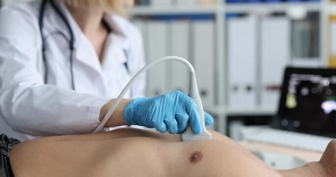 Female doctor examines patient heart using modern ultrasound echocardiography equipment in hospital operating room
