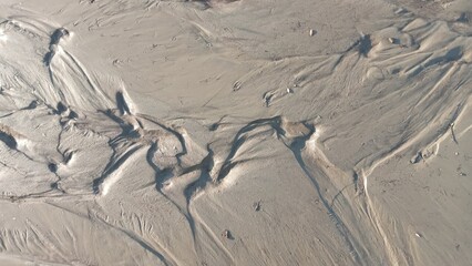 Dirty wet sand, grunge horizontal shabby background close-up. Blurry image of sand pattern....