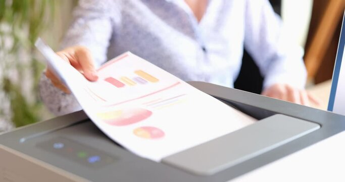 Office worker prints paper on multifunctional laser printer